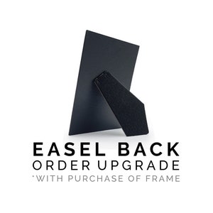 May include: Black easel back for a picture frame. The text on the back reads "Easel Back Order Upgrade *With Purchase of Frame"