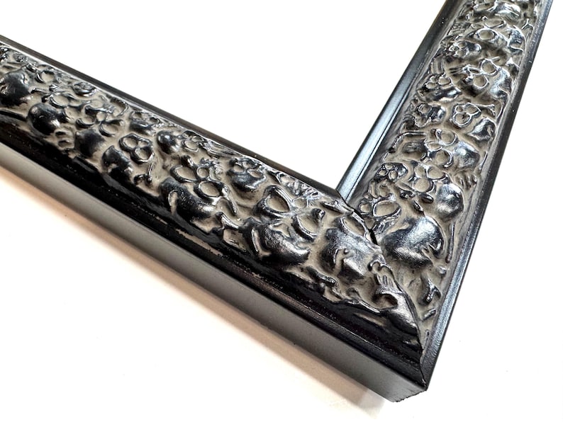 May include: Black picture frame with an ornate, textured design. The frame has a wide, flat profile and a smooth, black finish. Skulls Gothic Picture Frames Silver Black Eclectic Unique Photo Display Metallic Wood  Gift Wall Deco 4x6 5x7 8x10 11x14 16x20 18x24