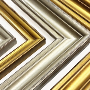 May include: Close-up of several picture frames with ornate, beveled edges. The frames are in various shades of gold and silver, with a metallic sheen. The frames are arranged at angles, showcasing their decorative details.