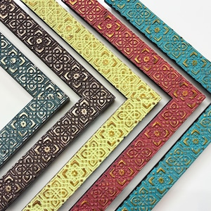 May include: Five L-shaped picture frame corner samples arranged in a diagonal row. Each frame features a repeating geometric embossed pattern with a distressed finish. The colors include dark blue, dark brown, light yellow, red, and bright turquoise.