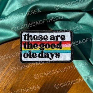 May include: A colorful embroidered patch with the text "These are the good ole days" in a rainbow stripe design.