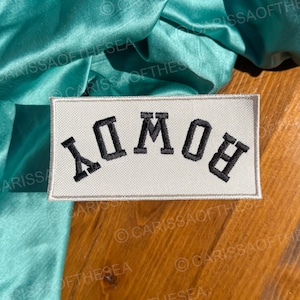 May include: White rectangular patch with black embroidered text that reads "Дом" in Cyrillic script.