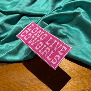 May include: Pink fabric patch with white embroidered text that reads "That's so 2020".