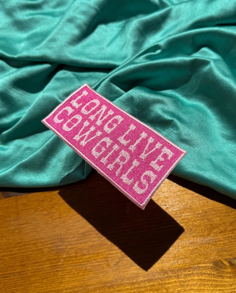 May include: Pink fabric patch with white embroidered text that reads "That's so 2020".