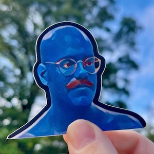 May include: A blue sticker of a man with a mustache and glasses. The man is wearing a blue shirt and has a bald head.