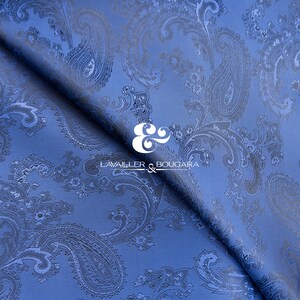 May include: Blue paisley patterned fabric with a white logo that reads "LAVAILLEUR & BOUGARA" in the center.