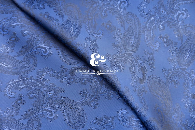May include: Blue paisley patterned fabric with a white logo that reads "LAVAILLEUR & BOUGARA" in the center.