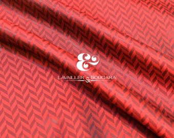 May include: Red fabric with a dark red herringbone pattern. The fabric is draped, showing folds and shadows. The brand name "LAVAILLER & BOUGARA" is displayed in white.