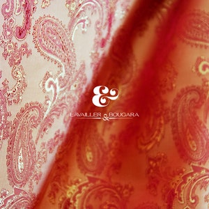 May include: Close-up of a red and gold paisley patterned fabric with the text "LAVAILLER & BOUGARA" in white.
