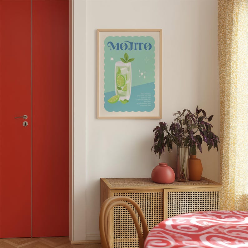 May include: A framed poster with the word "MOJITO" in blue lettering. The poster features a stylized illustration of a mojito cocktail with lime slices and mint leaves. The background is light blue and white.
