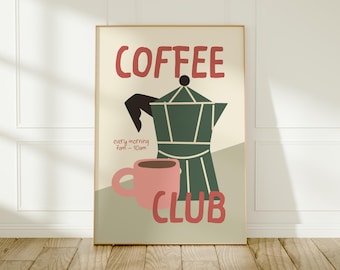 May include: A framed poster with a coffee theme. The word "COFFEE" is in red, above a green coffee maker and a pink mug. The words "CLUB" and "every morning 7am - 10am" are also in red.