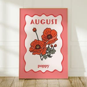 May include: A framed art print featuring a stylized illustration of orange poppies. The artwork is set against a cream background with a wavy pink border. The word "AUGUST" is at the top, and "poppy" is at the bottom.