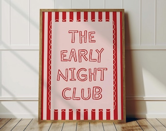 May include: A framed print with the text "THE EARLY NIGHT CLUB" in red on a light pink background. The print has a red and white striped border and is set in a wooden frame. The print is displayed on a wooden floor.
