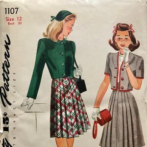 May include: Vintage Simplicity sewing pattern 1107 for a skirt and jacket. The pattern is for size 12 with a bust measurement of 30 inches. The pattern features two illustrations of women wearing the skirt and jacket. The jacket is green and the skirt is plaid. The second illustration shows a woman wearing a gray jacket and a gray skirt.