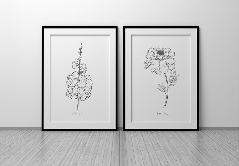 May include: Two framed botanical art prints. One features a detailed line drawing of a cluster of flowers, labeled "no. 13". The other depicts a peony, labeled "no. 23". Both are in black frames.