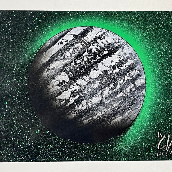 Black and white planet with green stars and shine