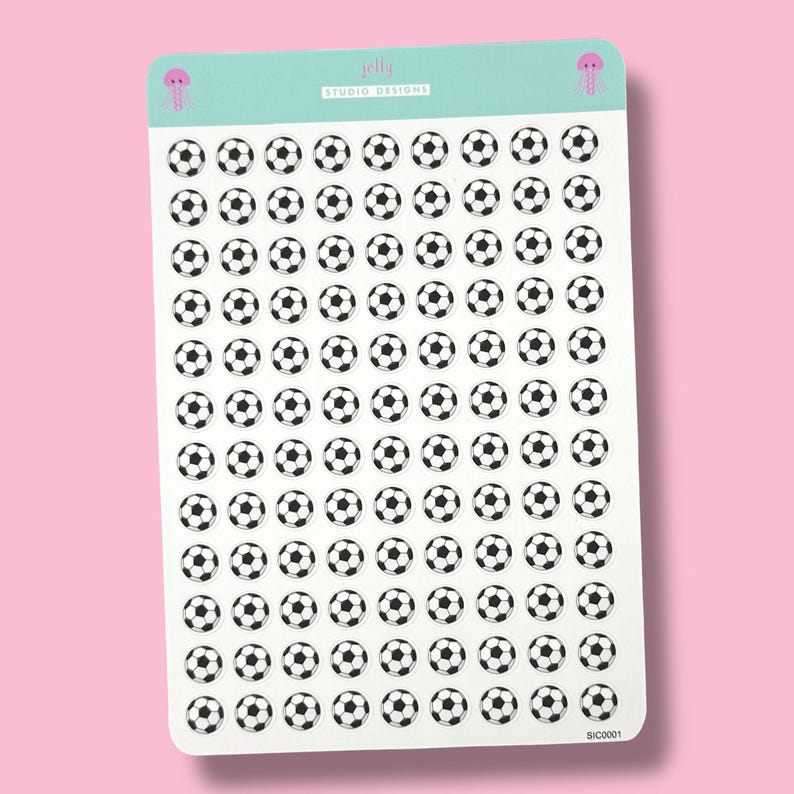May include: A sheet of stickers featuring numerous black and white soccer ball designs. The stickers are arranged in neat rows and columns on a white background. The top of the sheet has a light teal banner with the text "jelly studio designs" and a small pink jellyfish illustration.