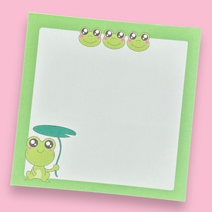 May include: Green notepad with a green frog holding a lily pad and four green frogs with pink cheeks around the border.