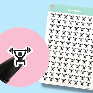 May include: Sheet of stickers featuring a black and white weightlifting icon. The stickers are on a white background with a light green header that says "jelly STUDIO DESIGNS" and a pink jellyfish icon. A single sticker is shown on a pink background.