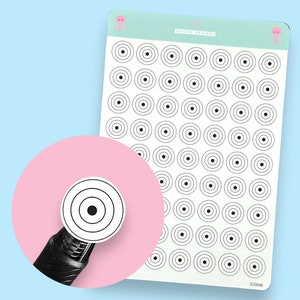 May include: A sheet of 60 black and white circle stickers with concentric rings. The stickers are arranged in a grid pattern. The sheet is labelled "Jelly Studio Designs" and "IC00448".