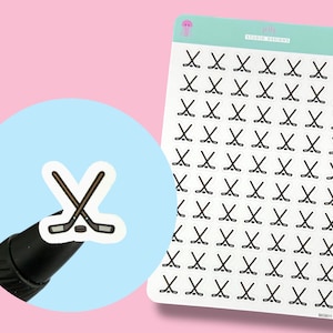 May include: Sheet of stickers featuring black and white hockey stick graphics. A close-up shows a single sticker with crossed hockey sticks and a puck. The sheet has a light teal header with the text "Studio Designs".