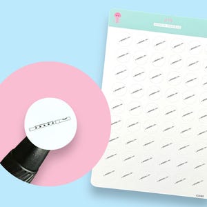 May include: A sheet of 48 white circle stickers with a black and white illustration of a flute on each sticker. The stickers are arranged in 8 rows of 6 stickers each. The sheet is printed with the text "Spirit of Light" in a light blue font.