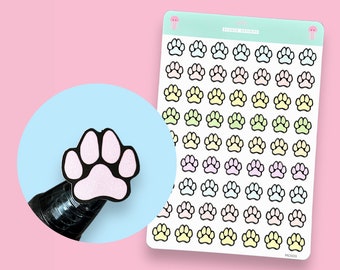 May include: A sheet of pastel paw print stickers. The sheet has 6 rows of 7 paw prints each. The paw prints are outlined in black and filled with pastel colors, including pink, blue, yellow, and green.