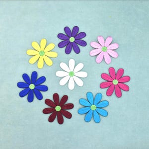May include: Eight embroidered flower patches arranged in a circular pattern. Each flower features eight petals in distinct colors including yellow, purple, pink, white, magenta, light blue, dark red, and dark blue, all with a central lime green circle.
