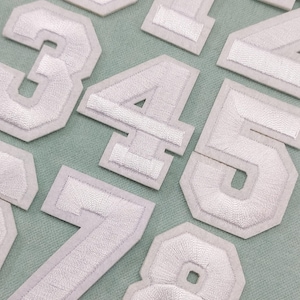 White number patches, embroidered iron-on number badges, to customize clothes and accessories
