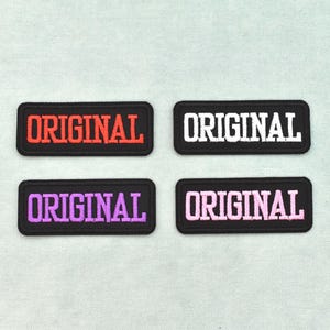 May include: Four rectangular embroidered patches with black borders and the word ORIGINAL stitched in the center. The top left patch features red text, the top right white, the bottom left purple, and the bottom right light pink text.