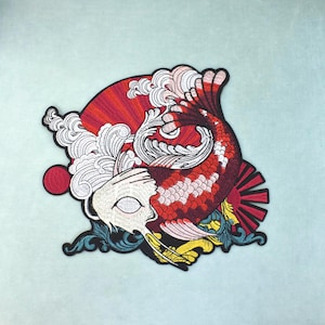 May include: An embroidered patch featuring a red and white koi fish swimming amidst stylised white waves. The design includes a red sun motif with radiating lines, accented by yellow and teal decorative scrollwork on a black outlined border.