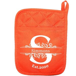 May include: Orange quilted pot holder with a white monogram design. The monogram features the letter "S" with a decorative flourish and the text "Simmons Est. 2020".