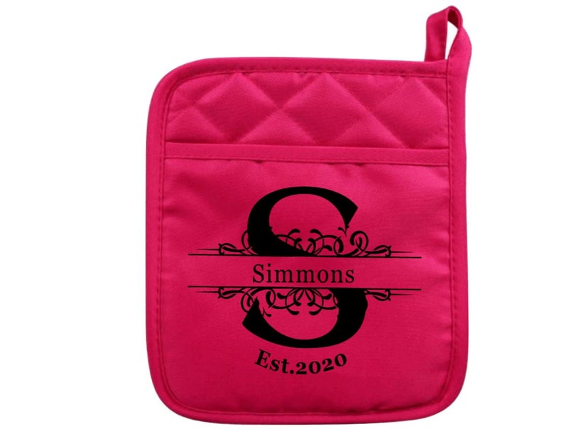 May include: Hot pink quilted oven mitt with a black monogrammed initial "S" with the name "Simmons" and the text "Est. 2020" in a decorative font.