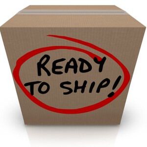 May include: A brown cardboard box with a red circle around the words "READY TO SHIP!" written in black marker.
