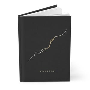 May include: A black hardcover book with white pages slightly open at the top. The front cover features a thin, jagged line design in white and gold, with the word REFORGED printed in small, capitalized gold letters near the bottom center.