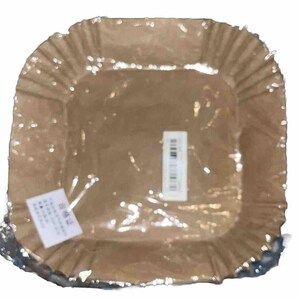 May include: A brown paper square plate with a fluted edge. The plate is wrapped in clear plastic and has a barcode sticker on it.
