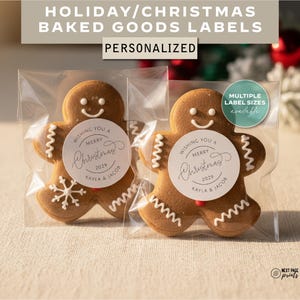 May include: Two gingerbread man biscuits in clear packaging, each with a white circular label that reads "Wishing You a Merry Christmas 2029, Kayla & Jacob." The image also includes text that says "Holiday/Christmas Baked Goods Labels, Personalized."