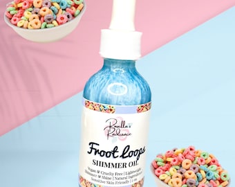 May include: A blue glass bottle with a dropper top, labeled "Borella's Radiance Froot Loops Shimmer Oil". The label also includes the text "Vegan & Cruelty Free | Lightweight Shimmer & Shine | Natural Ingredients | Sensitive Skin Friendly | 2 oz.". The bottle is surrounded by colorful cereal loops.