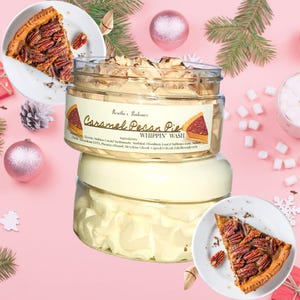 May include: A jar of "Caramel Pecan Pie Whippin' Wash" with a slice of pecan pie on a plate. The jar has a label with the product name and a pie slice graphic. The background is pink with holiday decorations.