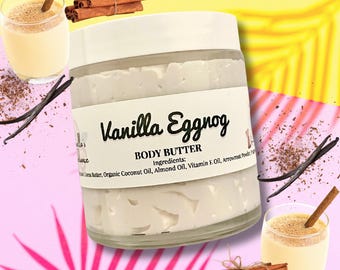 May include: A jar of Vanilla Eggnog body butter with a white lid and label. The label includes the product name and ingredients. The image also features a glass of eggnog, cinnamon sticks, and vanilla beans, all on a colorful background.
