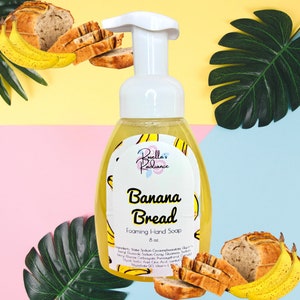 May include: A yellow and white bottle of foaming hand soap with a banana bread scent. The bottle is labeled "Borella's Radiance Banana Bread Foaming Hand Soap 8 oz."