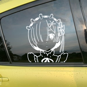 May include: A white vinyl sticker of a cartoon character with long hair, wearing a dress and a bow. The character is looking to the right. The sticker is on a yellow car window.