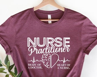 May include: A maroon t-shirt with the text "NURSE Practitioner" in white. The text is accompanied by a stylized brain and heart graphic with the text "BRAIN OF A DOCTOR" and "HEART OF A NURSE".