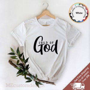 May include: White t-shirt with black text that reads "CHILD OF God" in a cursive font.