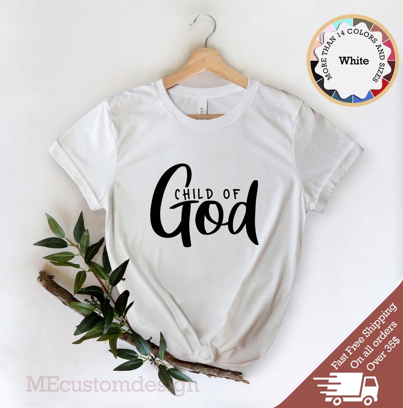 May include: White t-shirt with black text that reads "CHILD OF God" in a cursive font.