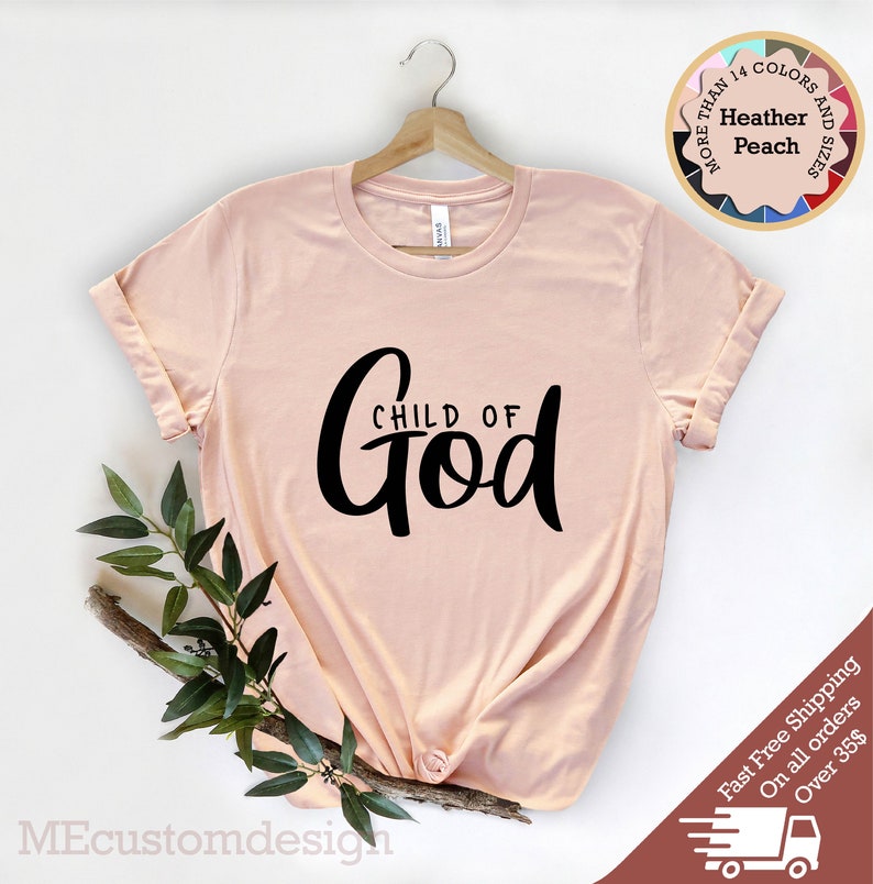 May include: A peach coloured t-shirt with the text "CHILD OF God" in black lettering.