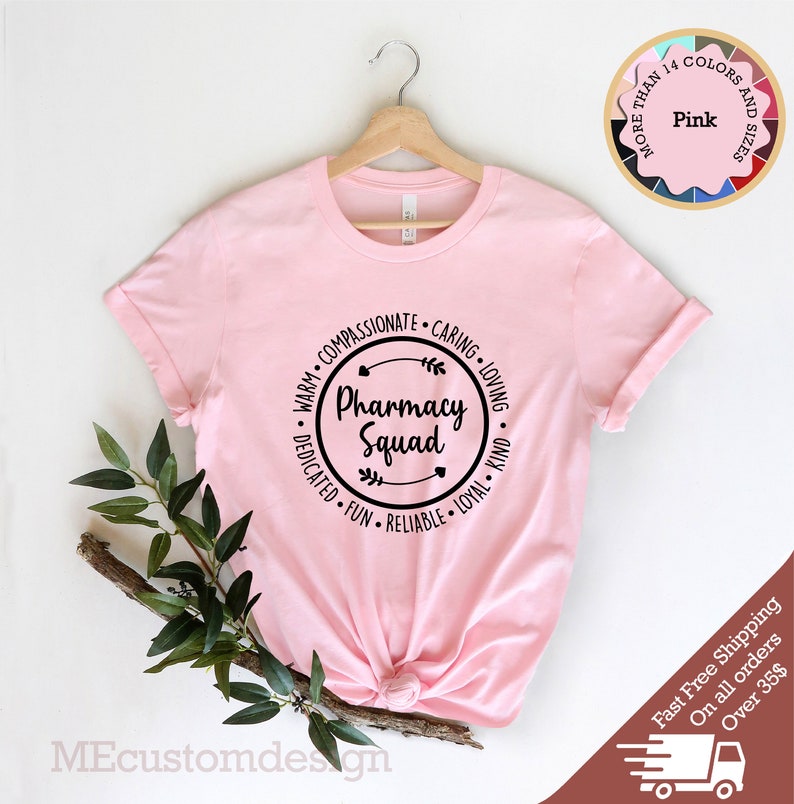 May include: Pink t-shirt with a black circle graphic that says "Pharmacy Squad" surrounded by the words "Warm, Compassionate, Caring, Loving, Dedicated, Fun, Reliable, Loyal, Kind".