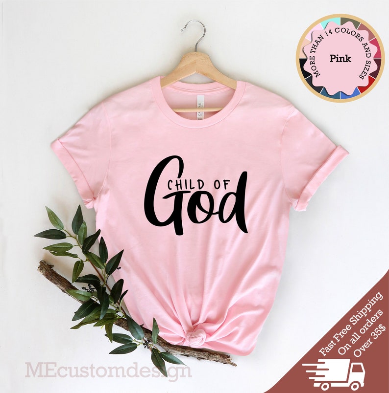 May include: Pink t-shirt with the text "CHILD OF GOD" in black script lettering.