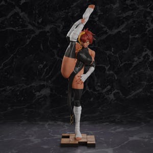 May include: A collectible figurine of a character with reddish-brown hair, wearing a black sleeveless bodysuit and white hand and leg wraps. The figure is posed in a high vertical split, standing on a brown wooden block base with a dark background.