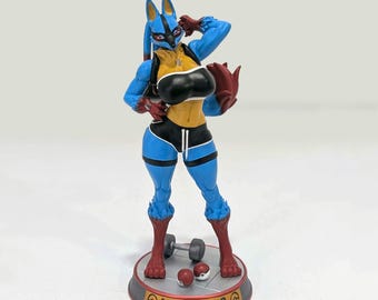May include: A Lucario figurine featuring a blue and black anthropomorphic character wearing a black sports bra and shorts. The figure stands on a circular base labeled LUCARIO with two small red and white spheres and a grey dumbbell at its feet.